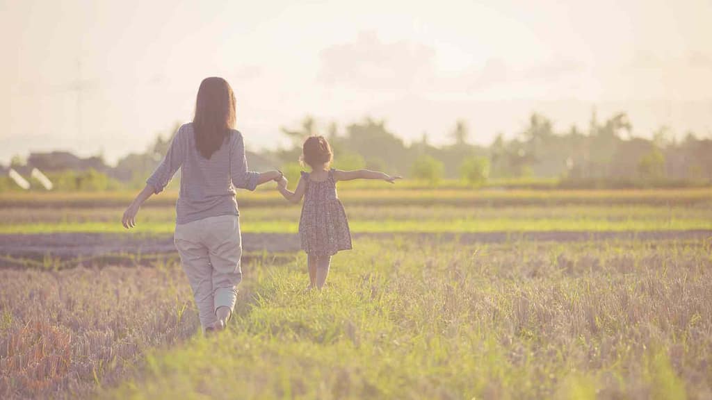 spiritualität im alltag frau hat spaß mit ihrem kind in der natur